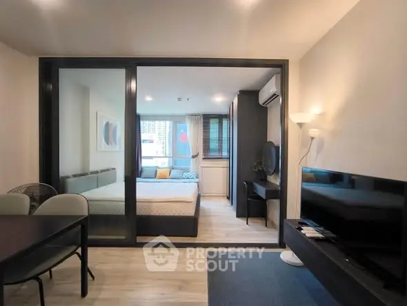 Modern studio apartment with open layout and stylish furnishings, featuring a cozy bedroom and living area.