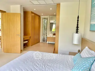 Modern bedroom with stylish decor and ensuite bathroom in luxury real estate property.
