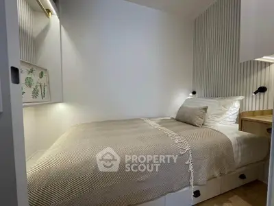 Cozy modern bedroom with stylish decor and built-in storage solutions.