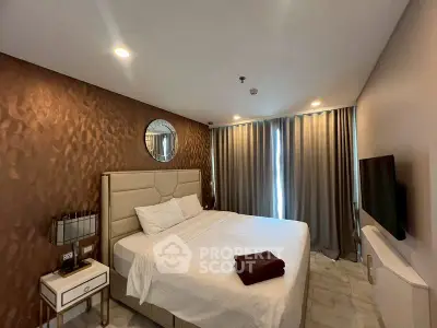 Luxurious bedroom with elegant decor and modern amenities, featuring a plush bed and stylish lighting.