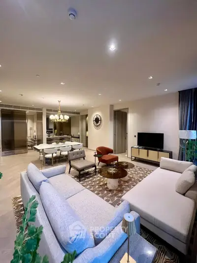 Luxurious open-plan living room with elegant decor and modern furniture in a spacious apartment.
