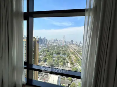 Stunning cityscape view from high-rise apartment window with lush greenery and skyline.