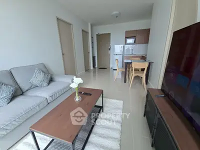 Modern living room with sleek furniture and open kitchen layout