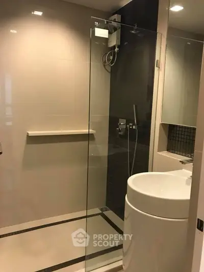 Modern bathroom with sleek glass shower and contemporary sink design