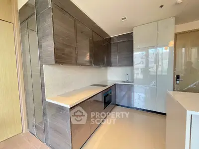 Modern kitchen with sleek cabinetry and built-in appliances in a stylish apartment.