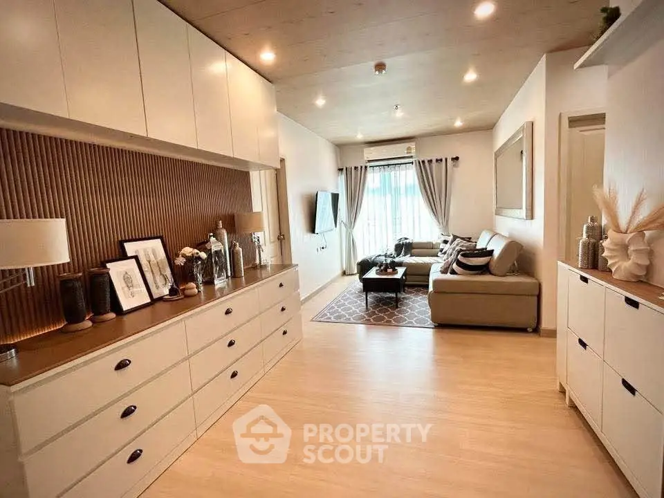 Spacious modern living room with elegant decor and ample natural light.