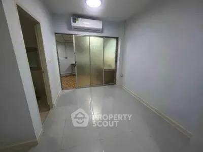 Spacious empty room with air conditioning and sliding glass doors