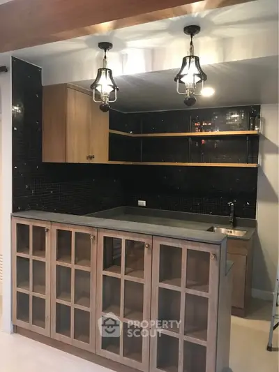 Stylish modern kitchen with elegant lighting and wooden cabinetry