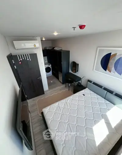 Modern bedroom with stylish decor and built-in storage, featuring a sleek design and ample natural light.