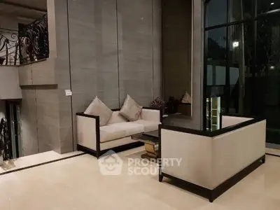 Luxurious modern living room with elegant furniture and large windows