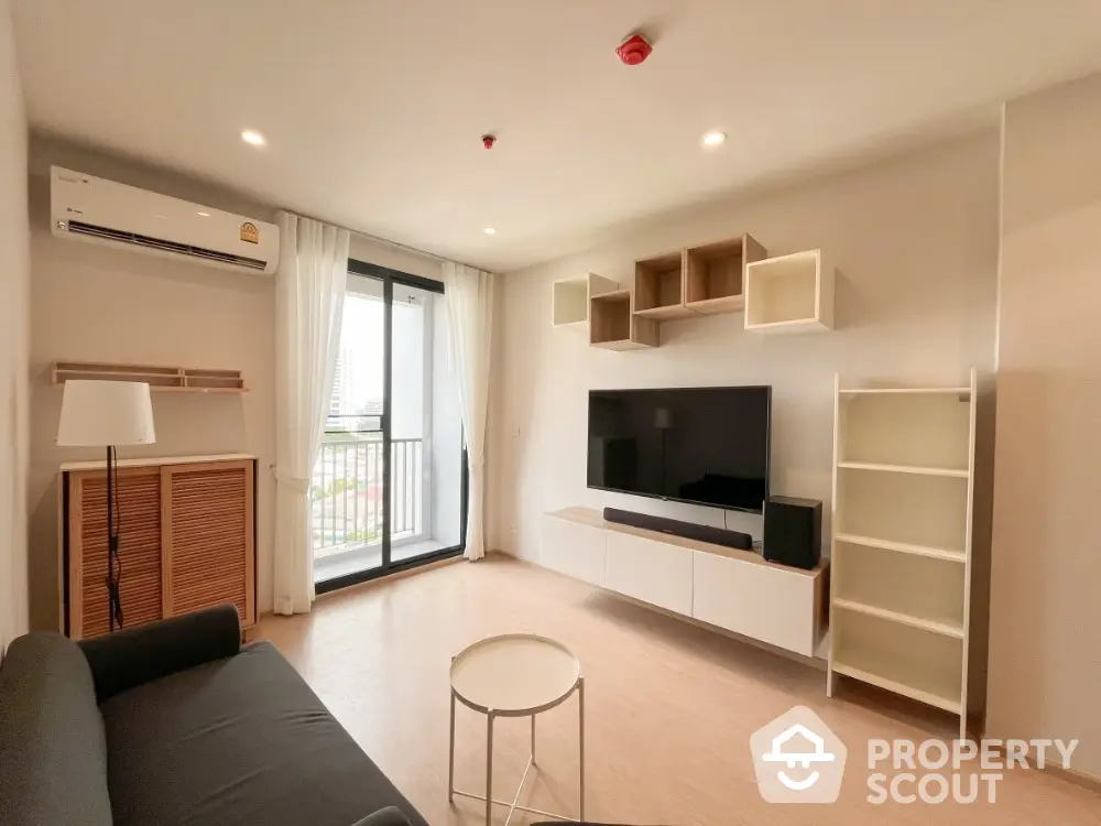 Modern living room with balcony view and stylish furniture