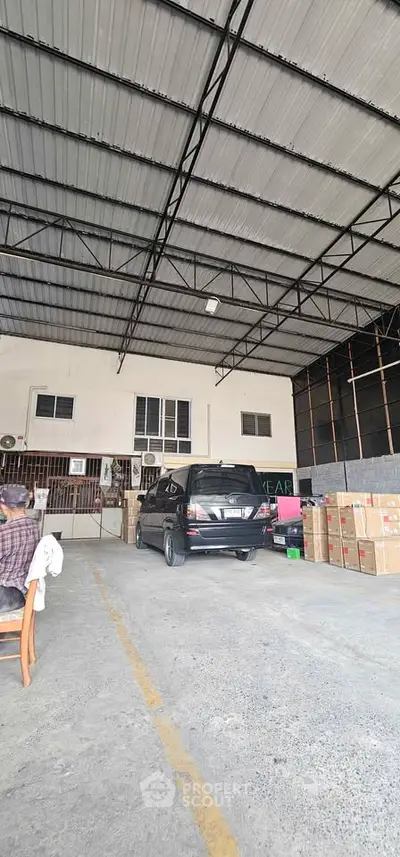 Spacious warehouse interior with high ceiling and ample storage space
