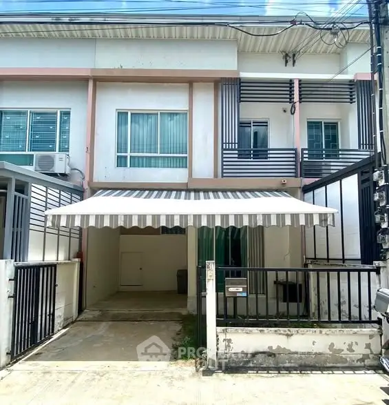 Charming two-story townhouse with gated entrance and covered parking in a serene neighborhood.
