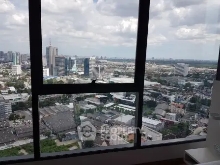 Stunning cityscape view from high-rise apartment window showcasing urban skyline.