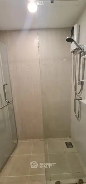 Modern bathroom with glass shower enclosure and sleek fixtures