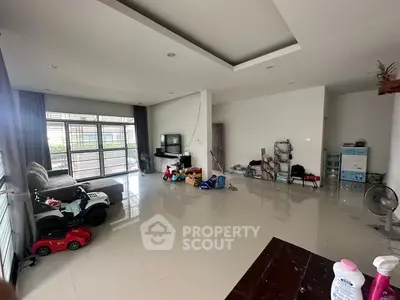 Spacious living room with modern decor and large windows for natural light.