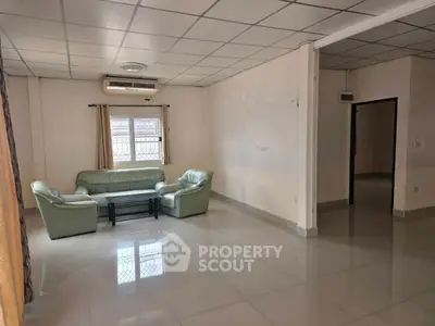 Spacious living room with modern tile flooring and comfortable seating