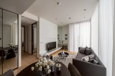 Modern living room with sleek furniture and large windows in a stylish apartment.