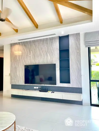 Modern living room with stylish TV wall unit and natural light