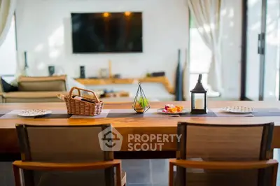 Modern living room with stylish decor and large TV, perfect for relaxation and entertainment.