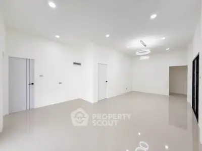 Spacious modern living room with elegant lighting and sleek tile flooring