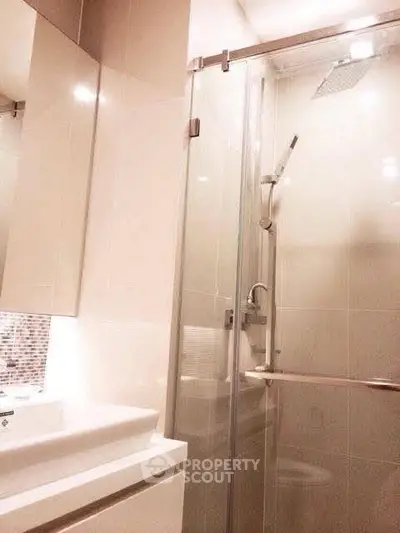 Modern bathroom with sleek shower and elegant fixtures in a stylish real estate property.