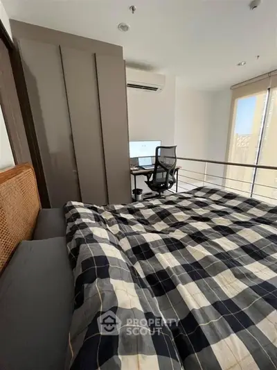 Modern bedroom with office setup and stylish decor