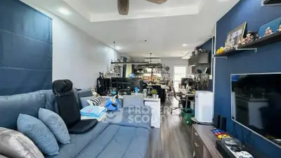 Spacious living room with modern decor and entertainment setup, perfect for relaxation and gatherings.