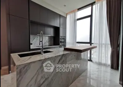 Luxurious modern kitchen with marble island and floor-to-ceiling windows