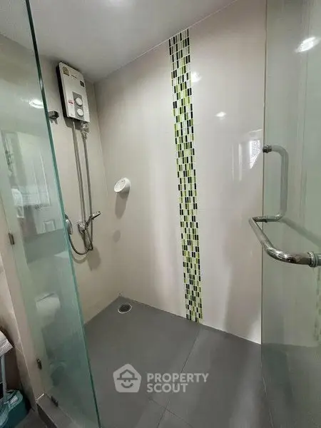 Modern bathroom with glass shower enclosure and stylish tile design