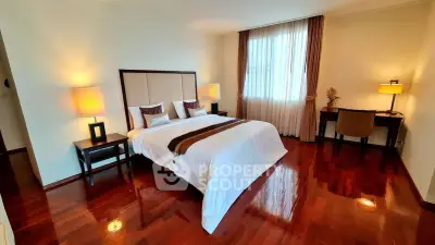 Elegant bedroom with polished wooden floors and cozy lighting
