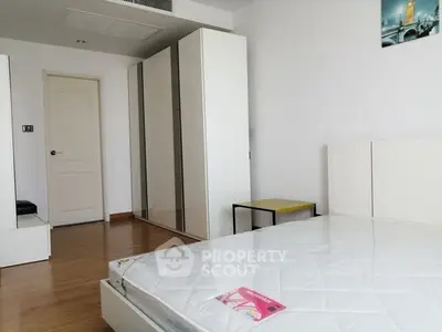 Modern bedroom with sleek wardrobe and minimalist design, perfect for urban living.