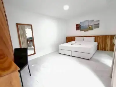 Spacious minimalist bedroom with modern decor and natural light