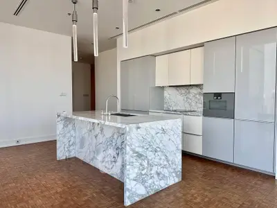 Luxurious modern kitchen with marble island and sleek cabinetry