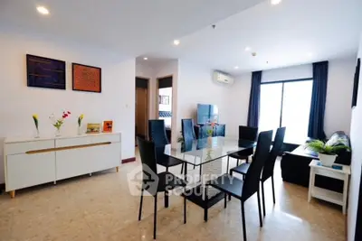 Spacious modern living room with dining area and large windows in a stylish apartment.