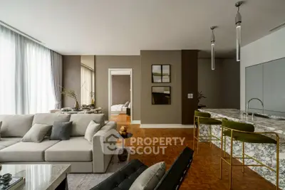 Luxurious open-plan living room with modern kitchen and elegant decor