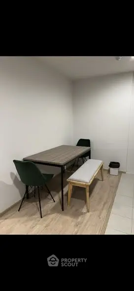 Modern dining area with sleek table and chairs in minimalist design.