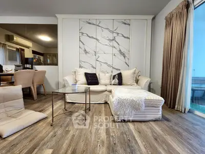 Stylish living room with modern decor and cozy seating area, featuring elegant flooring and natural light.