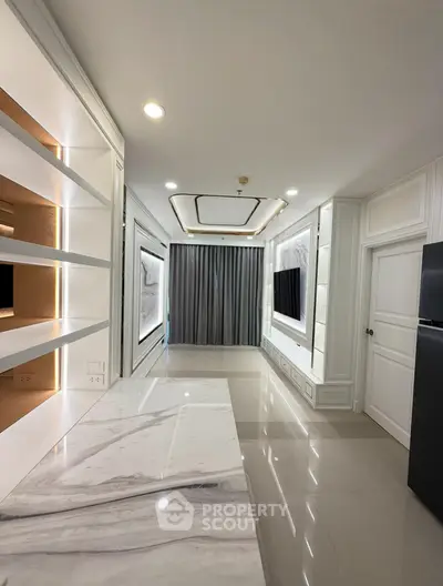 Luxurious modern interior with sleek marble flooring and elegant built-in shelving, perfect for sophisticated living.