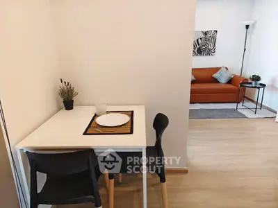Modern apartment interior with cozy dining area and stylish living room.