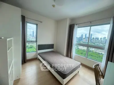 Modern bedroom with stunning city view and large windows in high-rise apartment