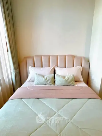 Cozy bedroom with elegant headboard and soft pastel bedding