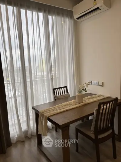 Charming dining area with natural light and elegant decor in modern apartment.