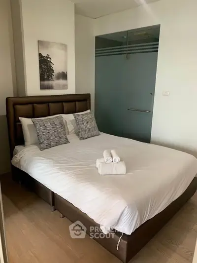 Cozy bedroom with modern decor and comfortable bed in stylish apartment.