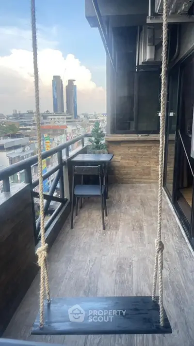 Charming balcony with swing and city view, perfect for relaxation and enjoying the skyline.