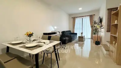 Modern living room with dining area, sleek furniture, and elegant decor in a cozy apartment.