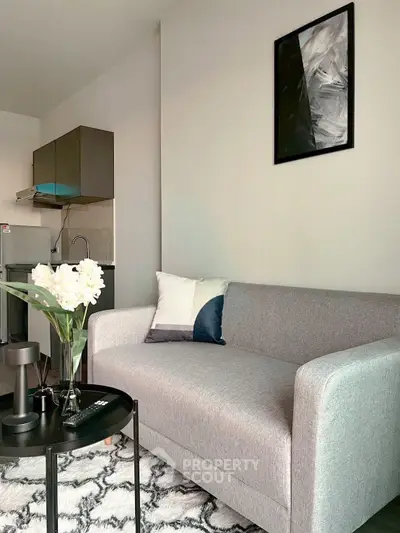 Modern living room with stylish gray sofa and chic decor in a contemporary apartment.
