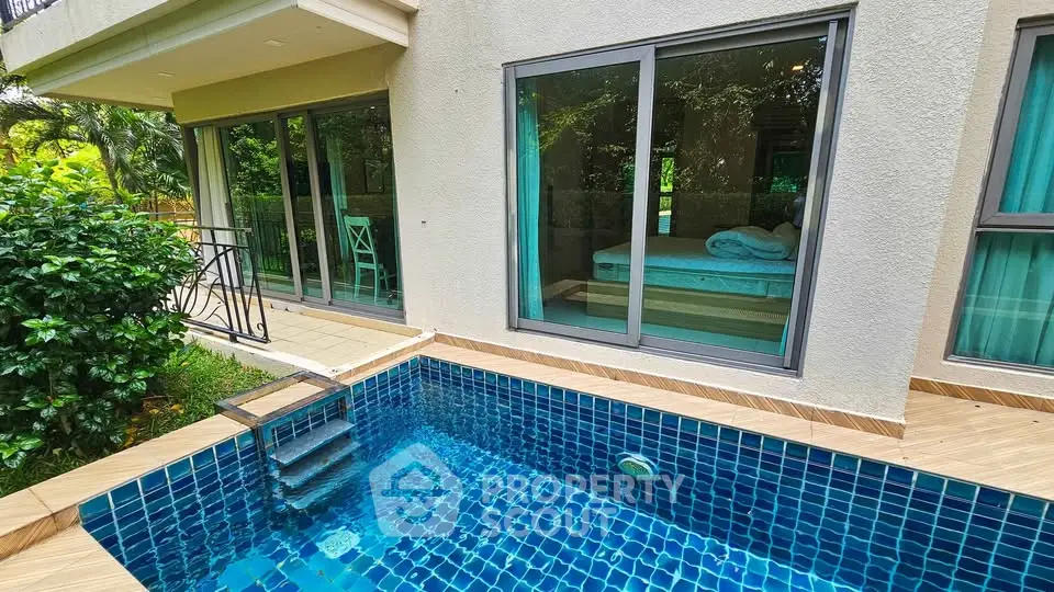 Luxurious ground floor unit with private pool and garden view, featuring modern sliding glass doors.