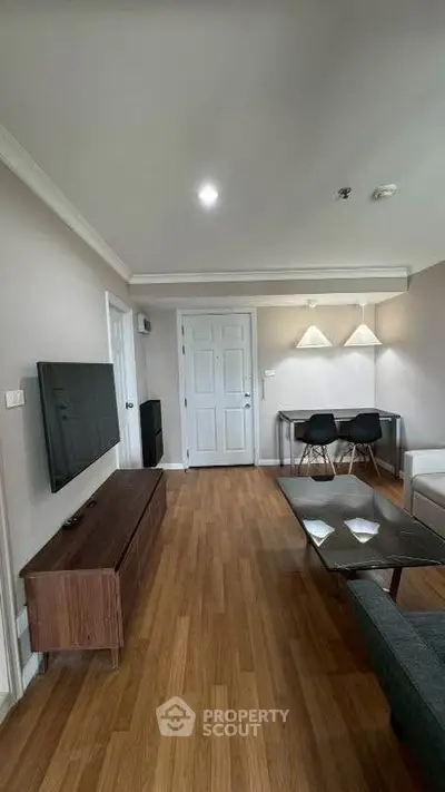 Modern living room with sleek furniture and wooden flooring, ideal for contemporary living.