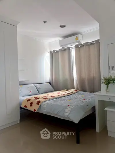Cozy bedroom with modern decor and natural light, featuring a comfortable bed and stylish furnishings.